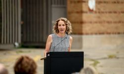 Amy Hovey, director and CEO of the Michigan State Housing Development Authority, at a podium. 