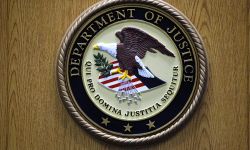 Justice Department logo on the wall. 