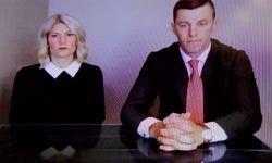 Stephanie Chatfield sits to the left of Lee Chatfield at a desk