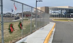 Outside view of Oxford High School. A memorial is on the side. 