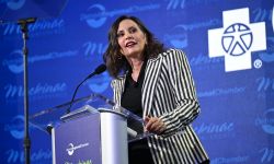 Gretchen Whitmer stands at podium