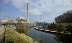A power plant is seen alongside a river