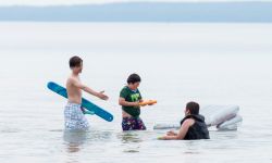 Kids swim in a lake