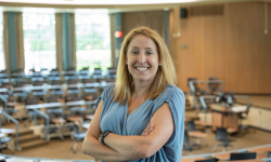 Kelley Cusmano poses for a photo in a classroom.