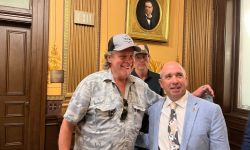 Ted Nugent poses for a photo with a state lawmaker in a hearing room at the Michigan state capitol