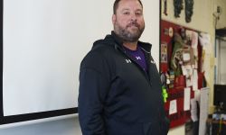 Corey Rosser poses for a photo in his classroom.