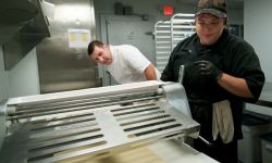 Two people prepare pastry dough