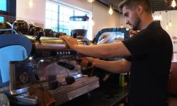 Man makes coffee in a shop