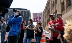 People holding 'ABOLISH ICE' sign