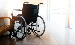 Wheelchair parked in hospital hallway.