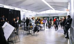 People gather in a large open room that is meant to serve as a refuge during climate disasters