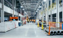 People walking in an auto plant.