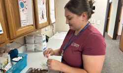 A nurse works with medical equipment in a clinic
