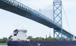 A freighter goes underneath the Ambassador Bridge.