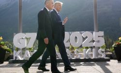 Canada's Prime Minister Mark Carney walks with President Donald Trump.