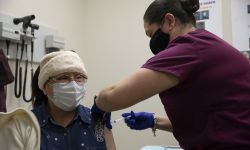 Jessica Andrade, a certified medical assistant, administers a COVID-19 vaccination to Maria Reina Garcia, 73, of Detroit on Friday at the CHASS Center in Detroit. 