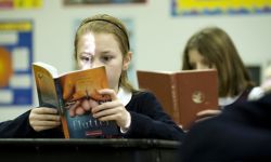 Students reading books at their desks in a classroom