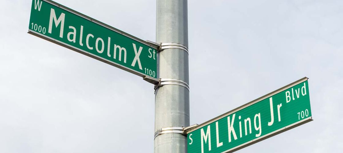 Street signs for Martin Luther King Jr and Malcolm X. Civil rights leaders in Lansing Michigan