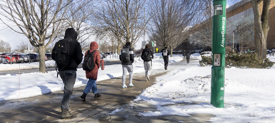 Students walking on a college campus. 