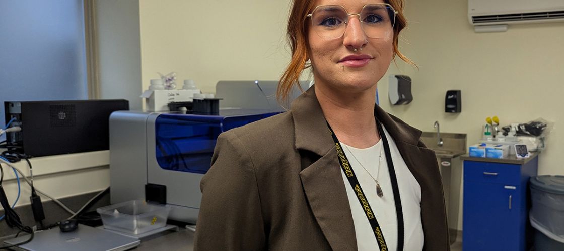 Penny Nowlin stands in a lab.