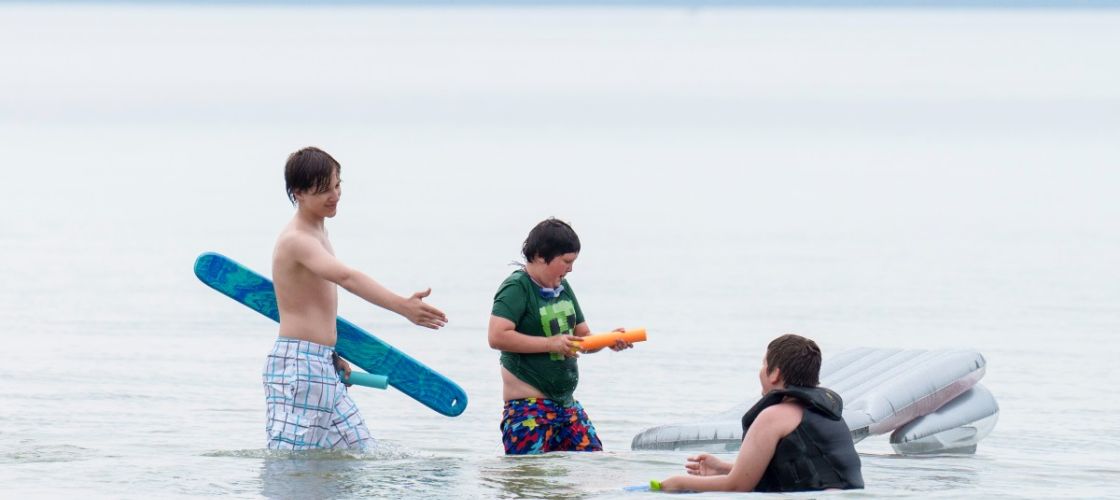 Kids swim in a lake