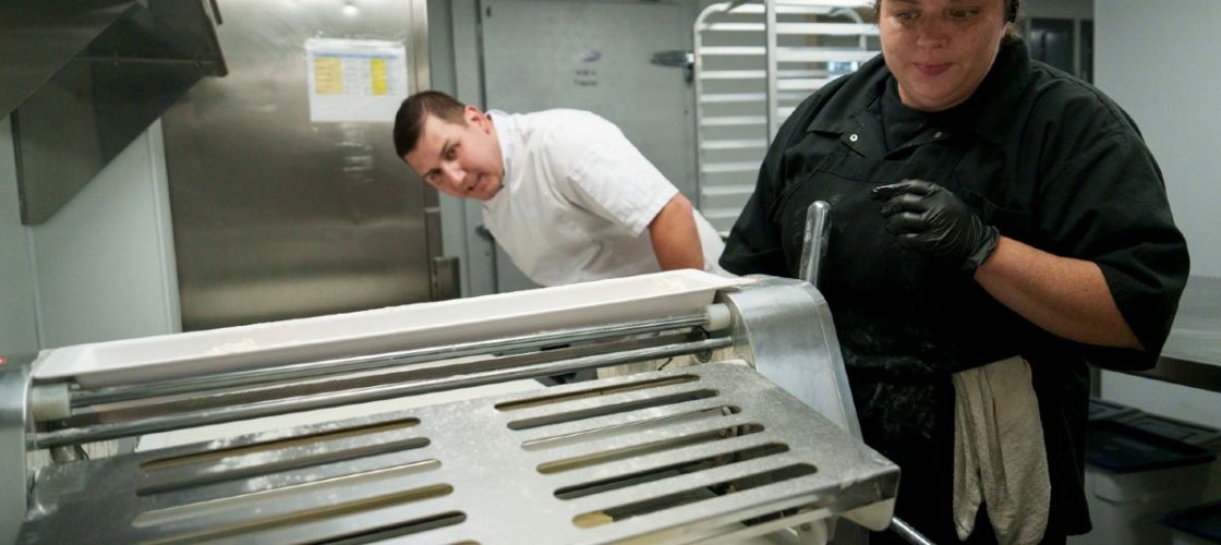 Two people prepare pastry dough