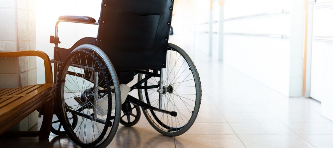 Wheelchair parked in hospital hallway.