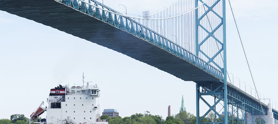 A freighter goes underneath the Ambassador Bridge.